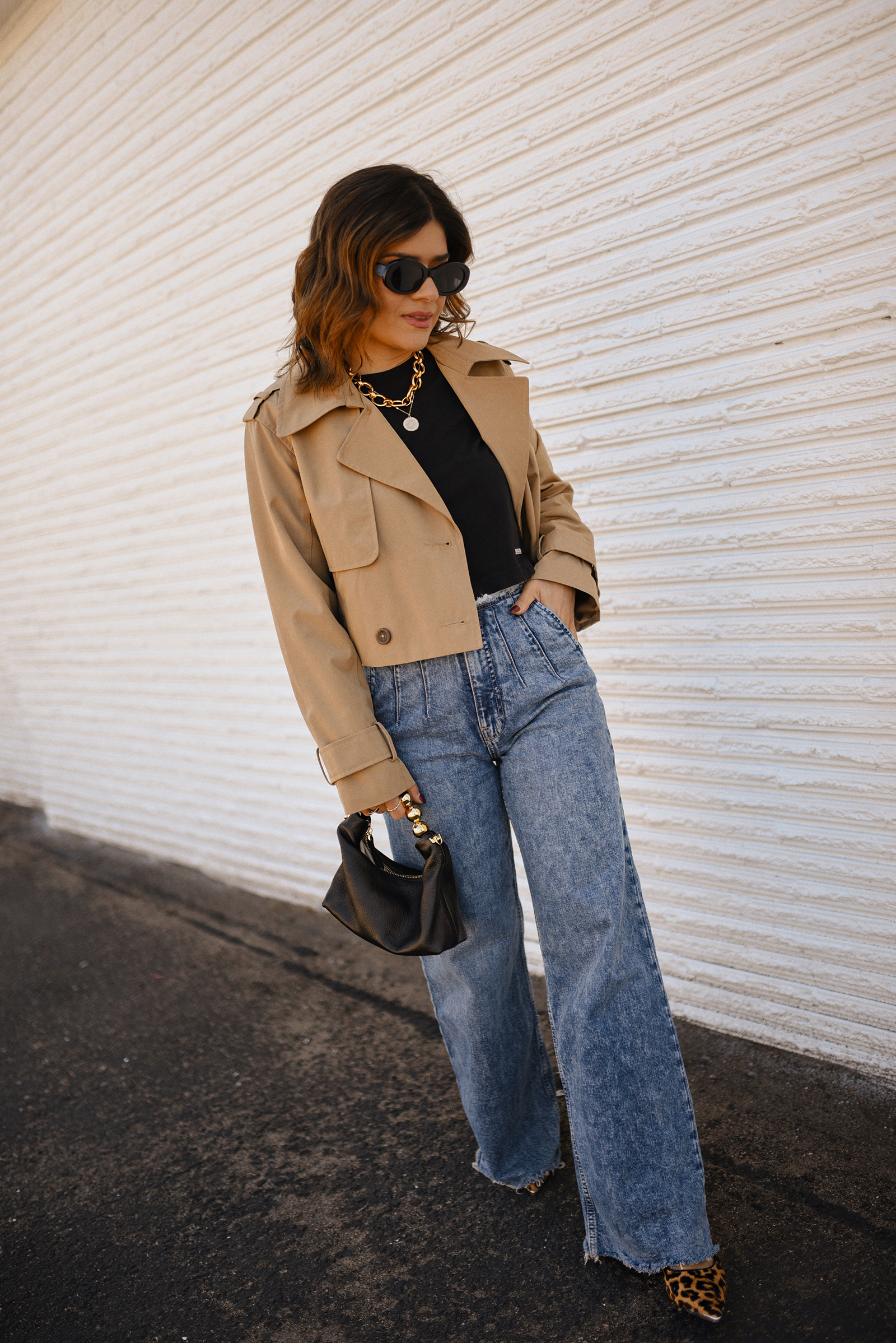 Carolina Hellal of Chic Talk wearing a short trench coat via Abercrombie, tshirt and jeans from Hudson jeans, Nordstrom animal print pumps and Amazon black handbag