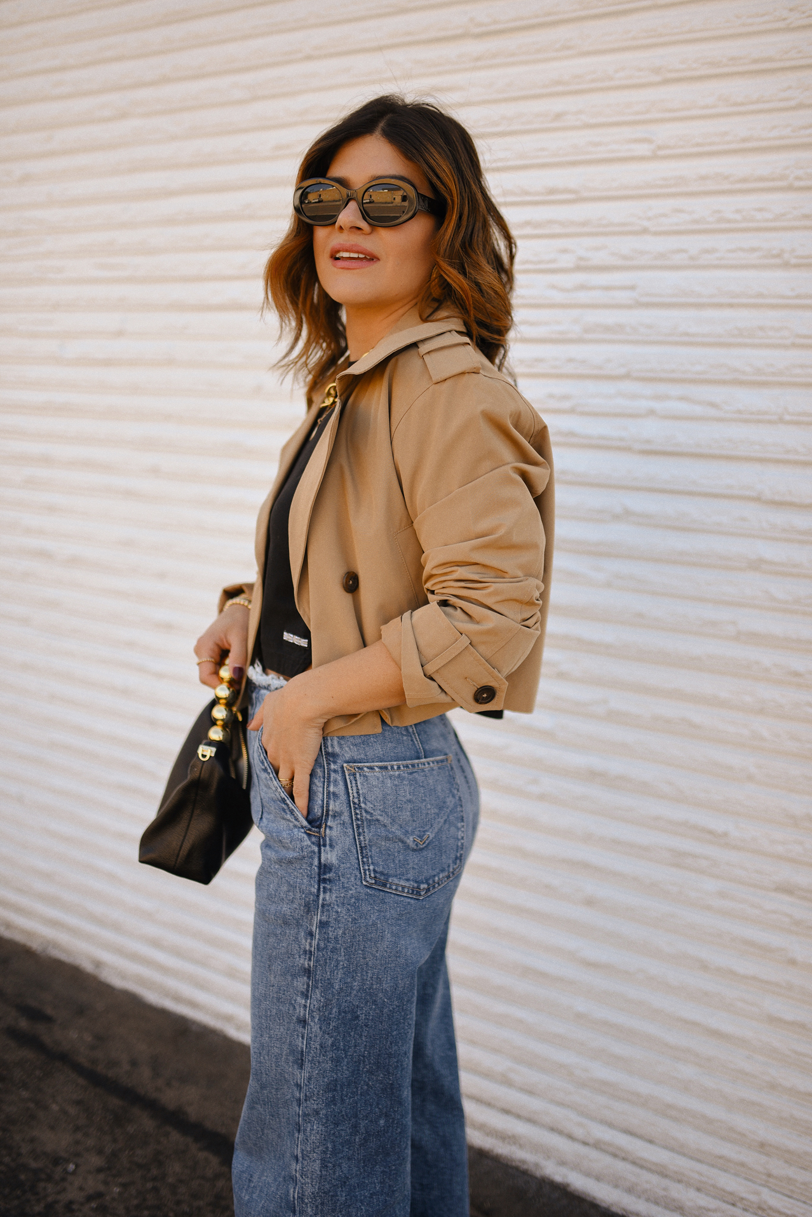 Carolina Hellal of Chic Talk wearing a short trench coat via Abercrombie, tshirt and jeans from Hudson jeans, Nordstrom animal print pumps and Amazon black handbag