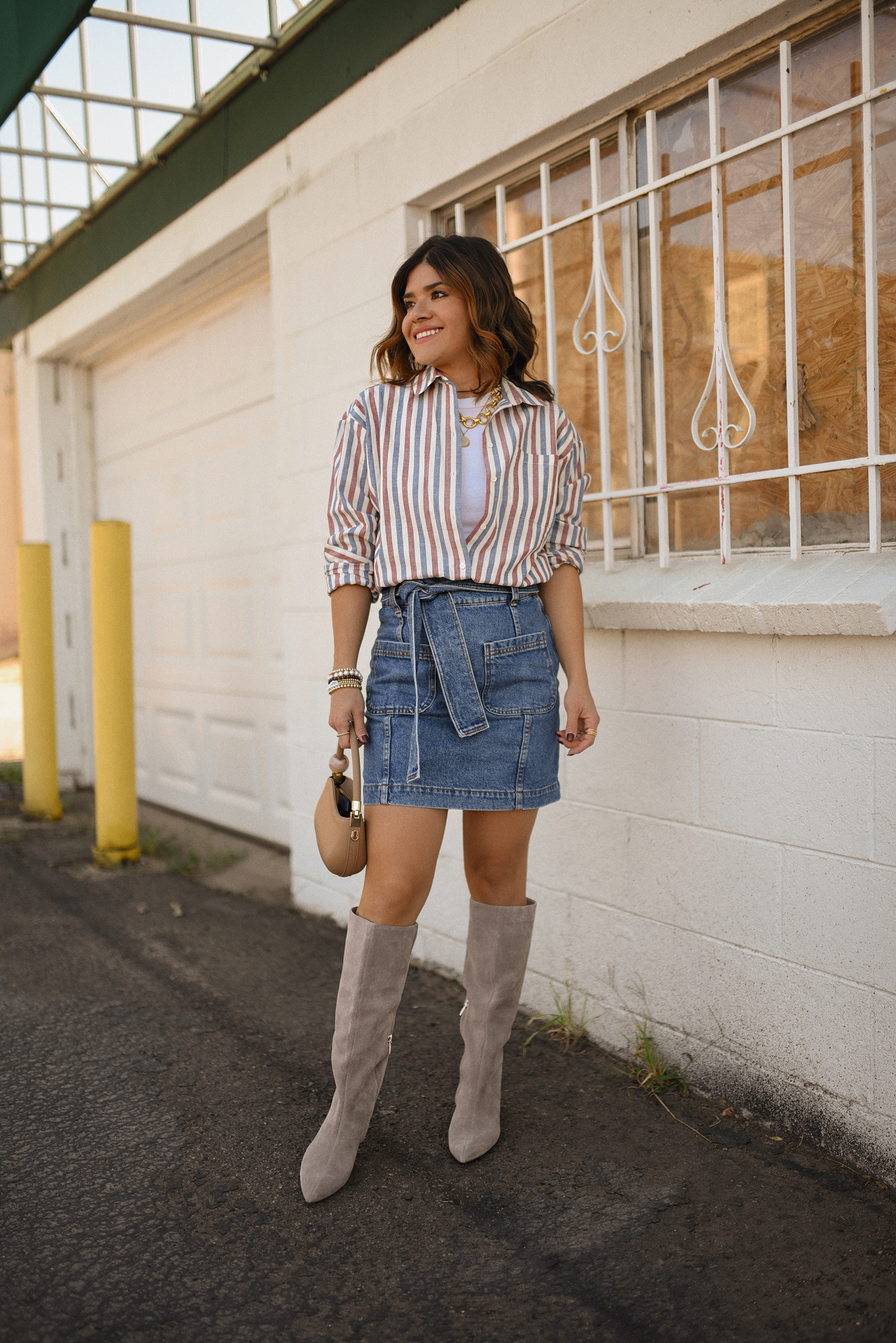 Carolina Hellal of Chic Talk wearing a total look via Sezane, denim mini skirt and stripped shirt, Nordstrom nude boots, and nude handbag