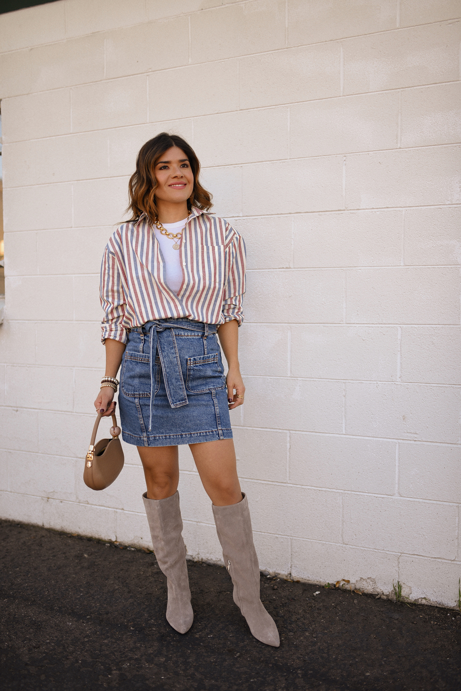 Carolina Hellal of Chic Talk wearing a total look via Sezane, denim mini skirt and stripped shirt, Nordstrom nude boots, and nude handbag