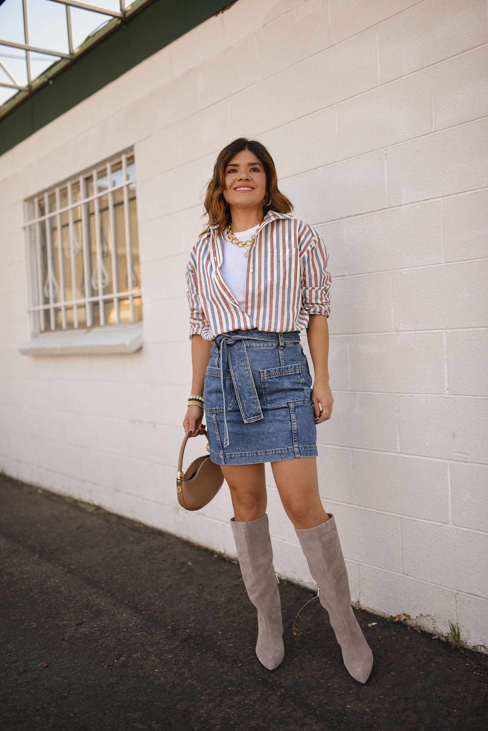 Carolina Hellal of Chic Talk wearing a total look via Sezane, denim mini skirt and stripped shirt, Nordstrom nude boots, and nude handbag