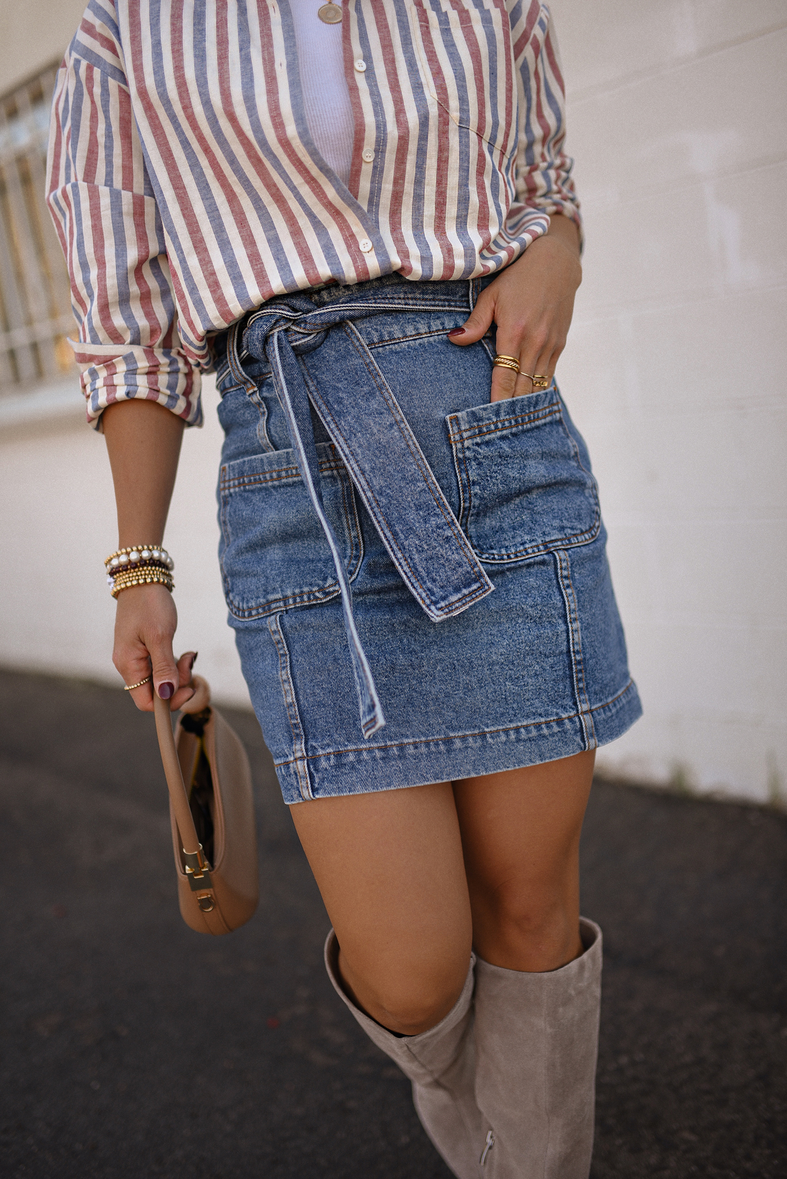 Carolina Hellal of Chic Talk wearing a total look via Sezane, denim mini skirt and stripped shirt, Nordstrom nude boots, and nude handbag