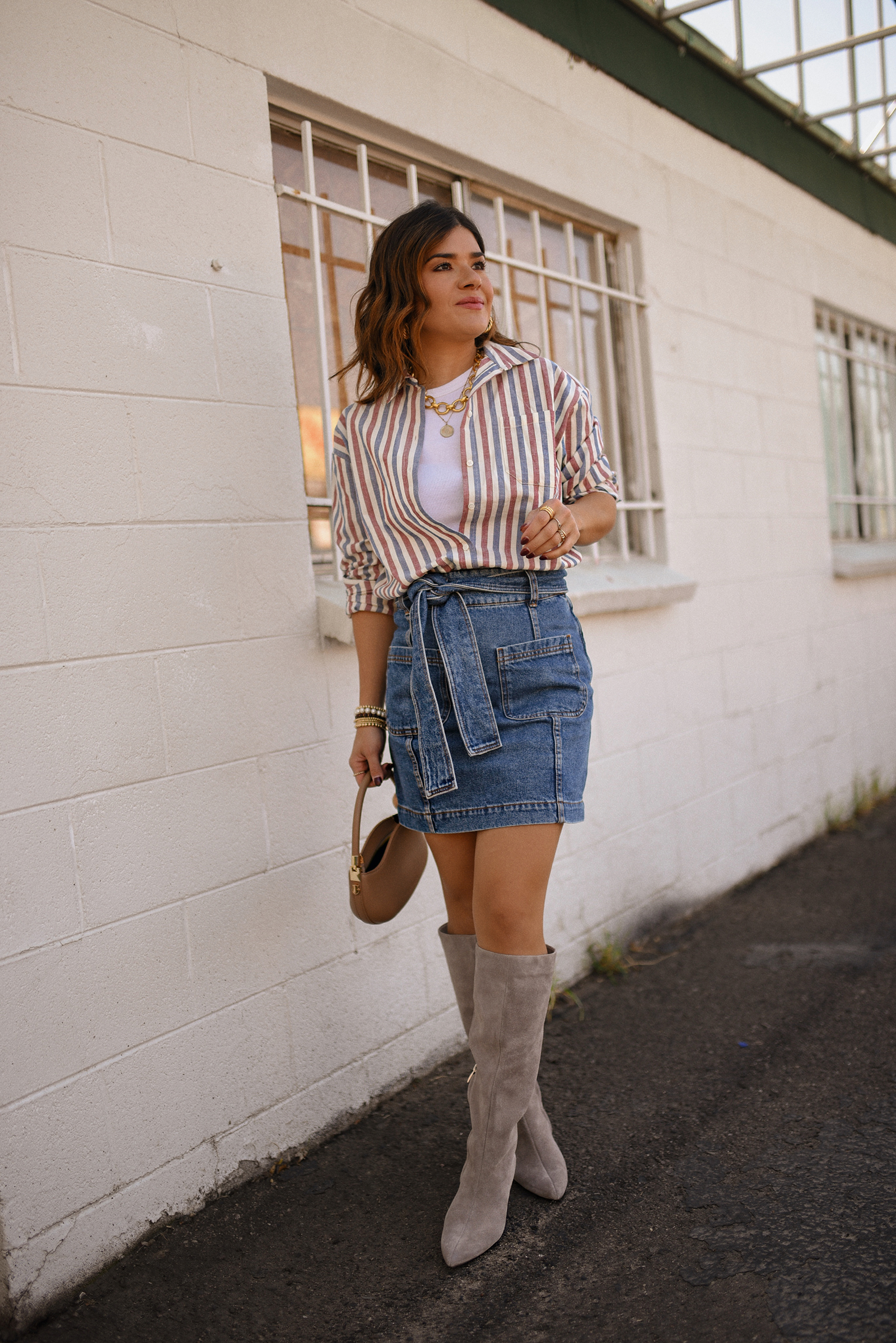 Carolina Hellal of Chic Talk wearing a total look via Sezane, denim mini skirt and stripped shirt, Nordstrom nude boots, and nude handbag