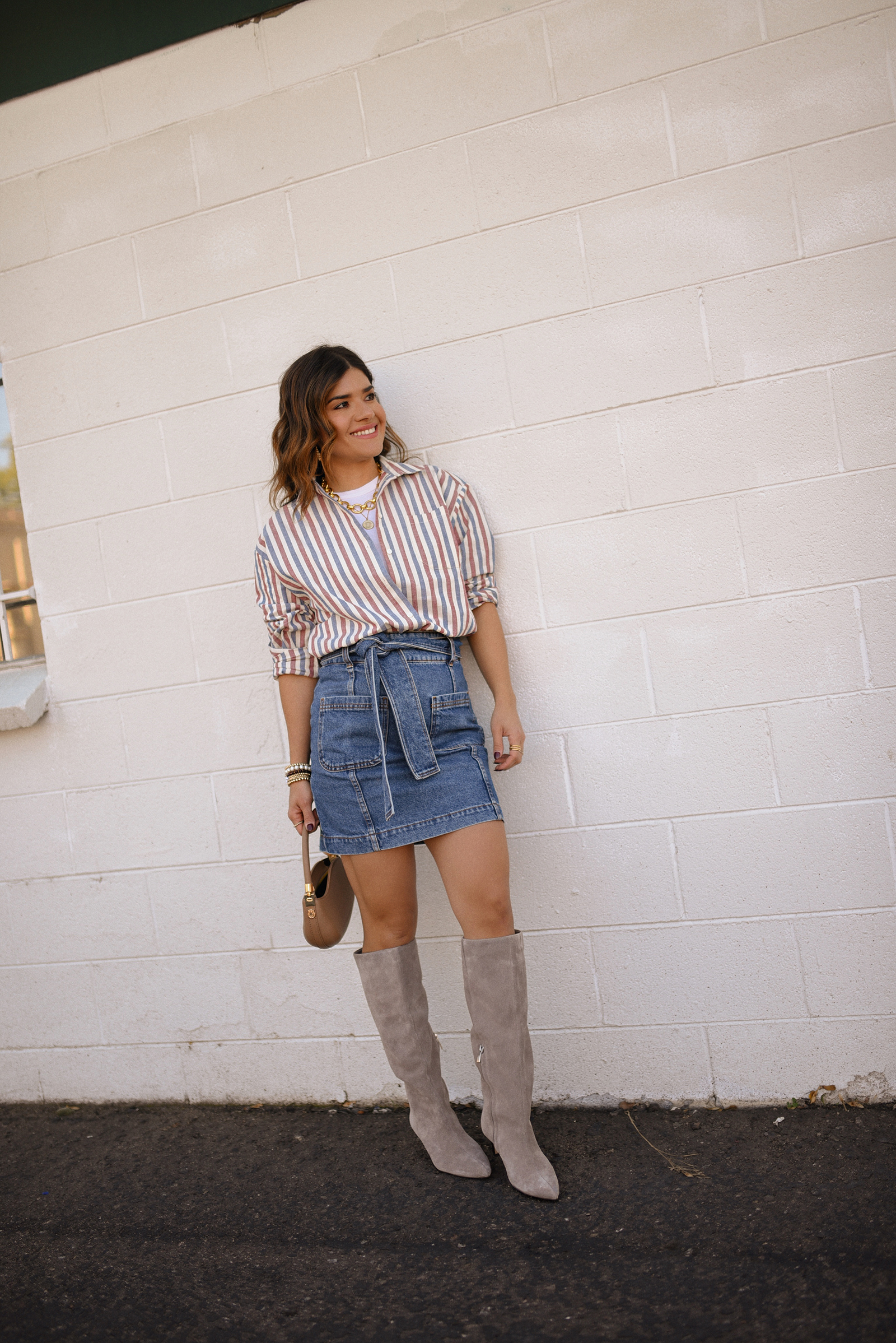 Carolina Hellal of Chic Talk wearing a total look via Sezane, denim mini skirt and stripped shirt, Nordstrom nude boots, and nude handbag