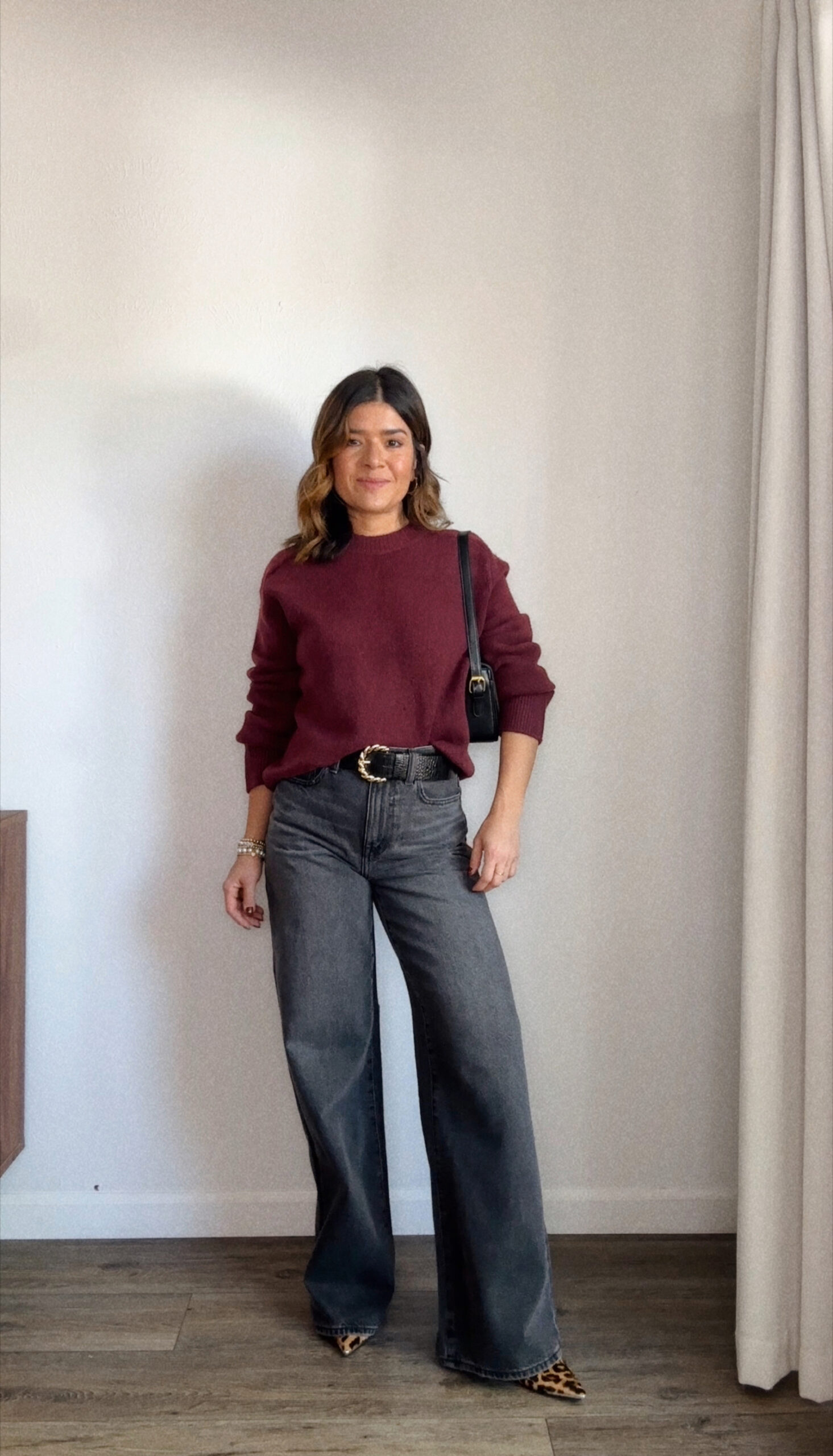 Carolina Hellal of Chic Talk wearing a wide leg jean via Madewell, a burgundy sweater via Walmart Fashion, Franco Sarto animal print pumps and Amazon handbag